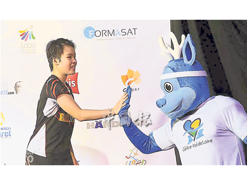 吴堇溦（左）在奥尔良挑战赛颁奖礼上接受吉祥物击掌祝贺。（照片源自Clto Badminton面书）