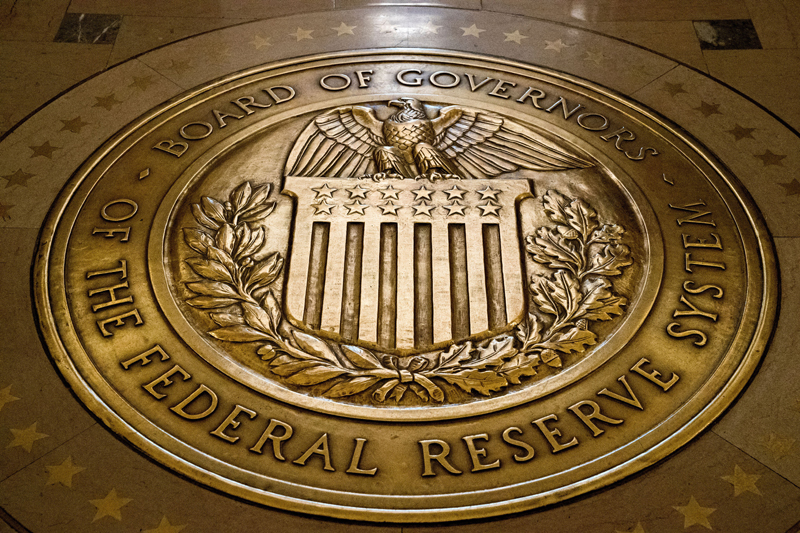 FILE - The seal of the Board of Governors of the United States Federal Reserve System is displayed, Feb. 5, 2018, in the ground at the Marriner S. Eccles Federal Reserve Board Building in Washington. To Wall Street's relief, the end appears in sight for the Federal Reserve's sharp hikes to interest rates. The hikes are supposed to lower inflation, but they also hurt the economy and drag down stock prices. (AP Photo/Andrew Harnik, File)