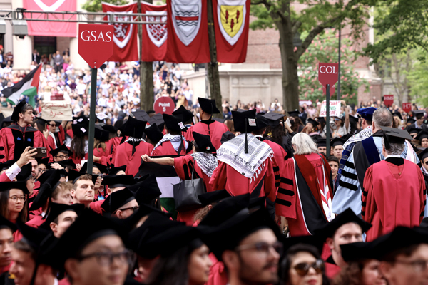 epa11364701 Harvard students wearing keffiyehs walk out of a commencement ceremony in protest of the Israel-Hamas conflict during the 373rd Commencement ceremony at the Harvard University in Cambridge, Massachusetts, USA, 23 May 2024.  EPA-EFE/MARK STOCKWELL
