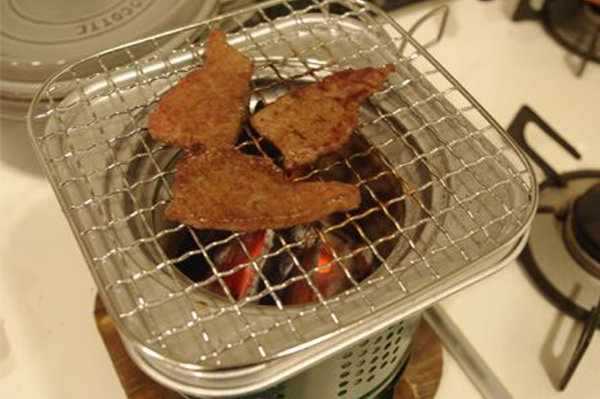 室内烧炭烤肉，务必注意通风换气。（示意图）